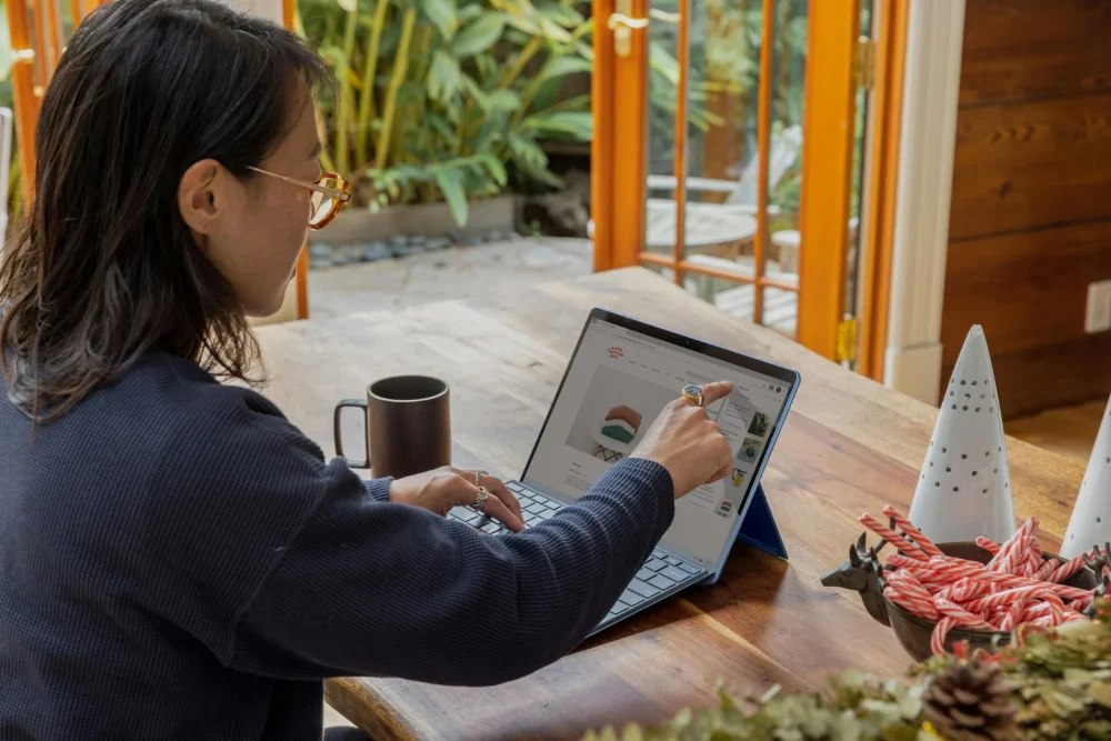 woman pointing at the laptop screen